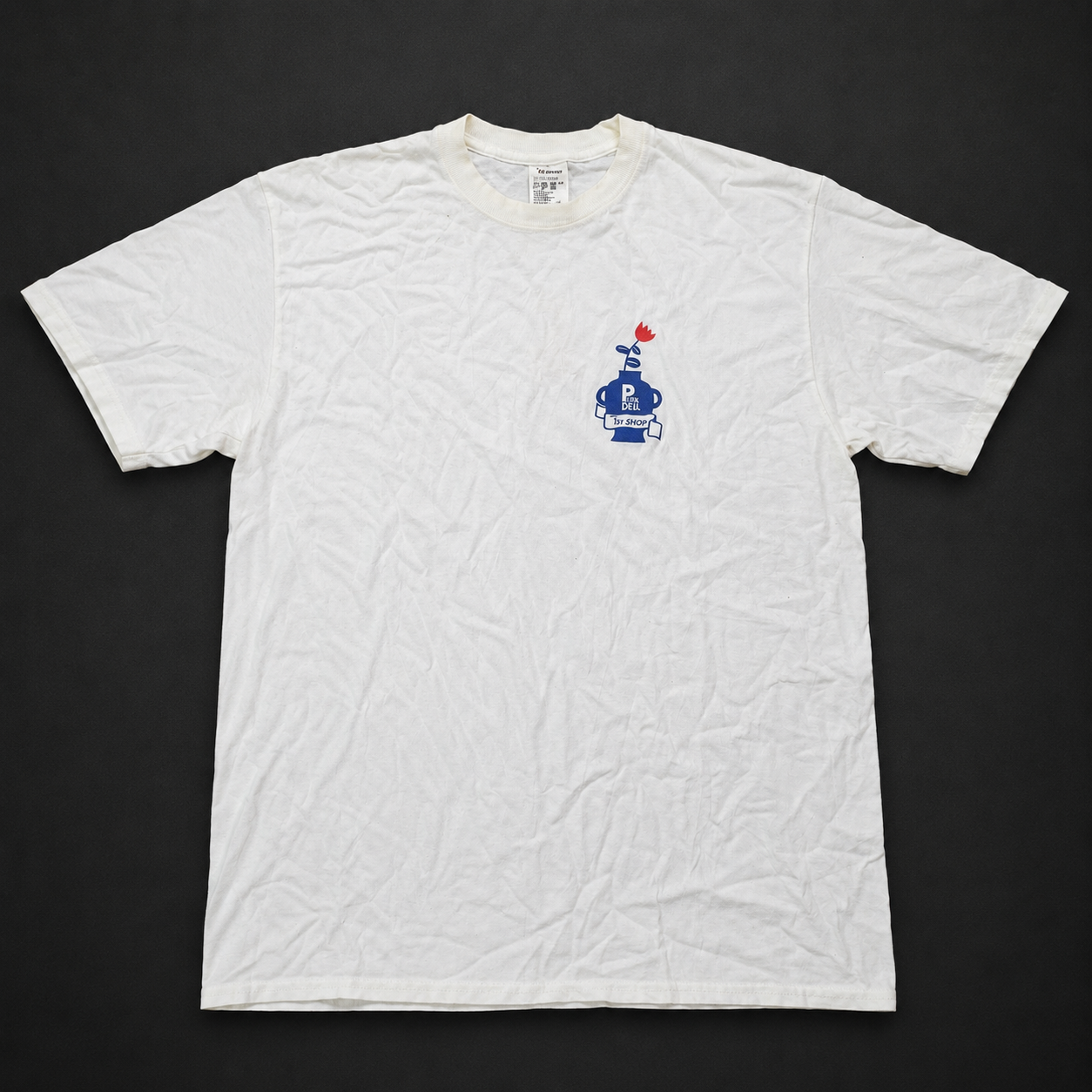 White Small Character Chest Graphic Tee, one-of-one pre-loved apparel from Quality Thrift